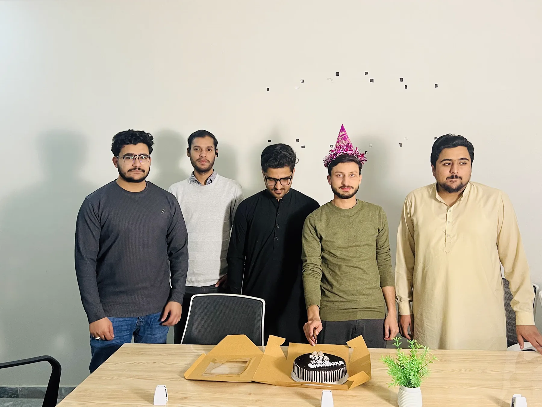 AI Data House colleagues celebrating together in the office