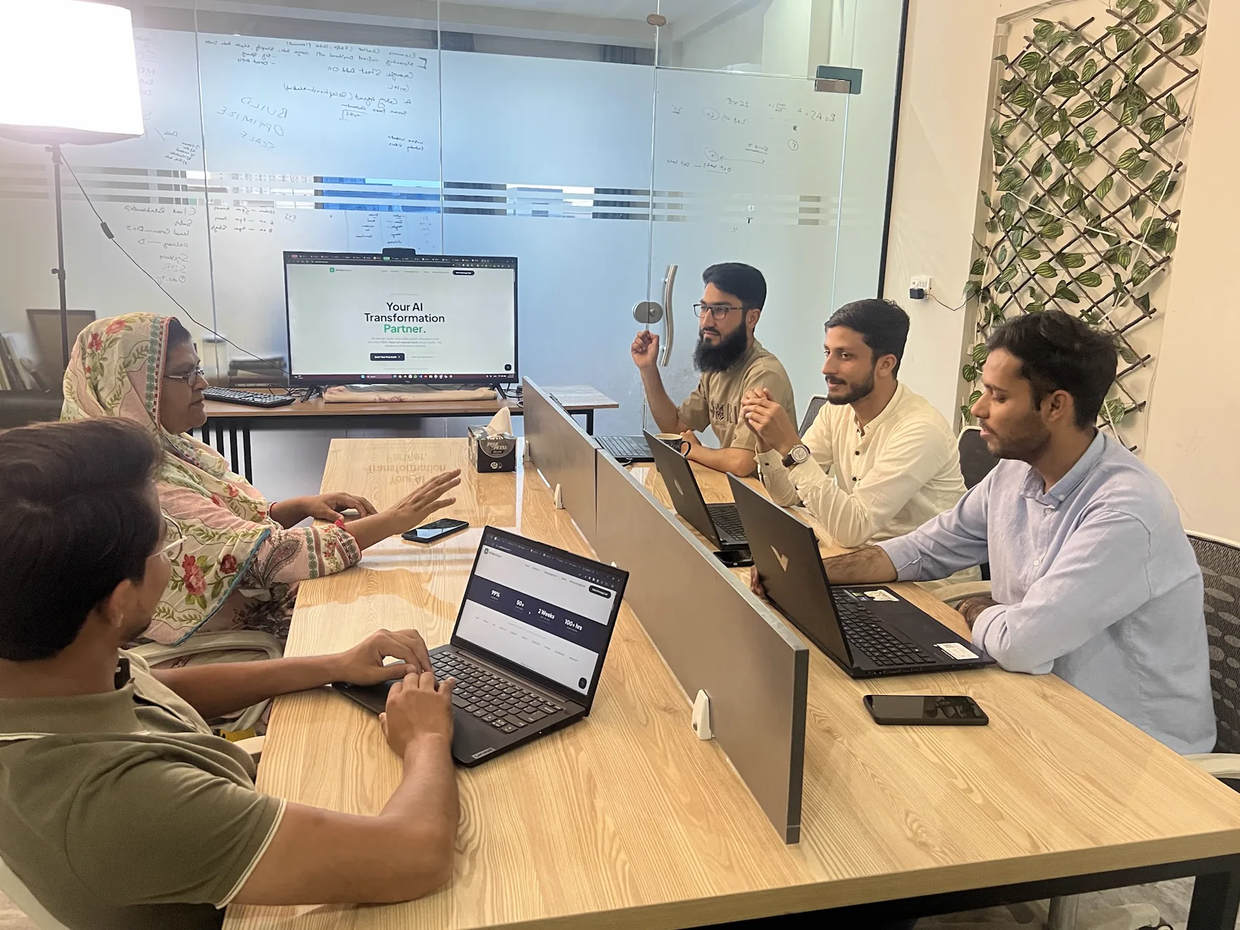 AI Data House team collaborating around a meeting table